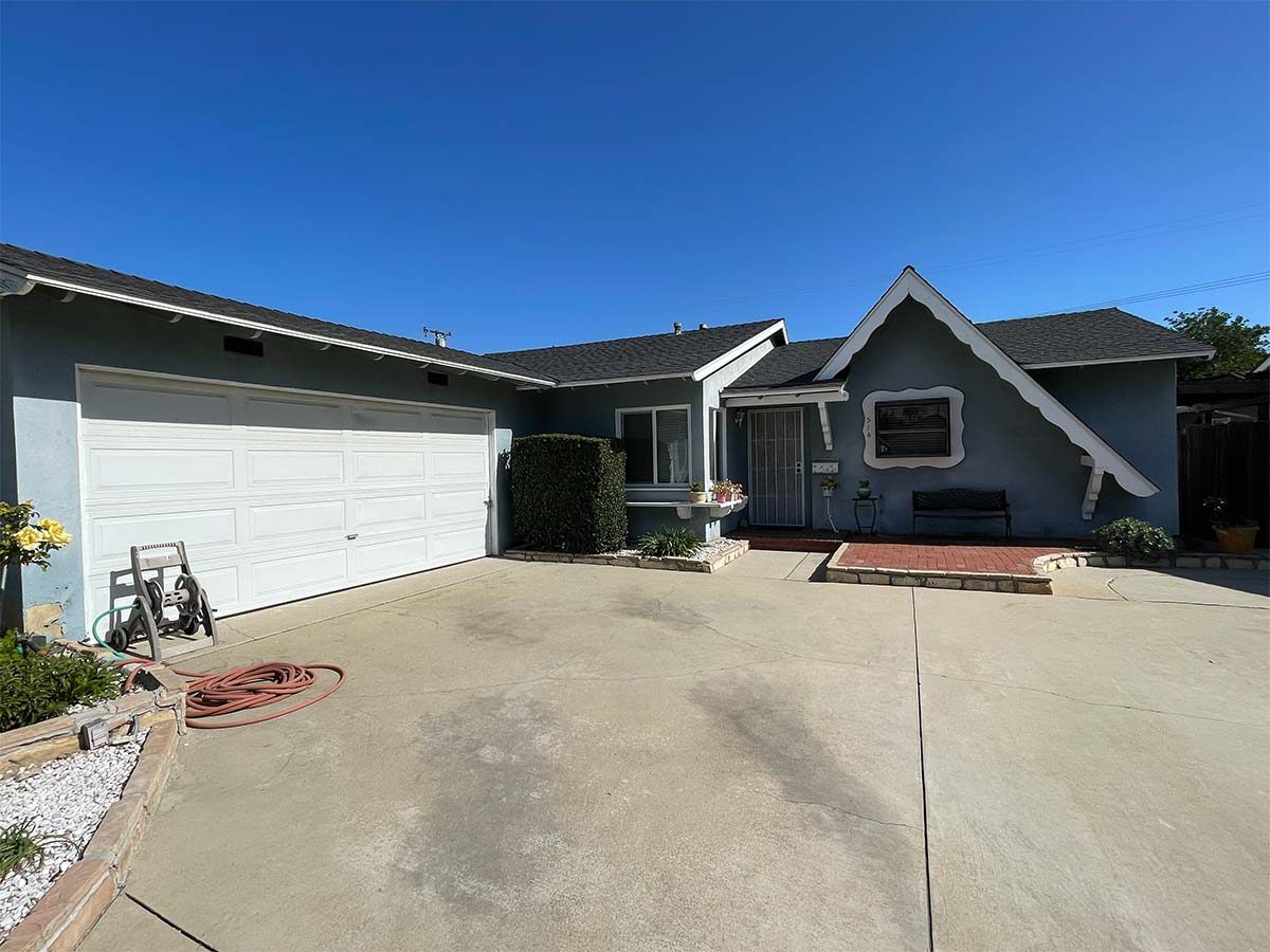 Close-up front view of 514 N Balton Ave, San Dimas, showing the attached two-car garage, white garage door, covered entry and wide concrete driveway